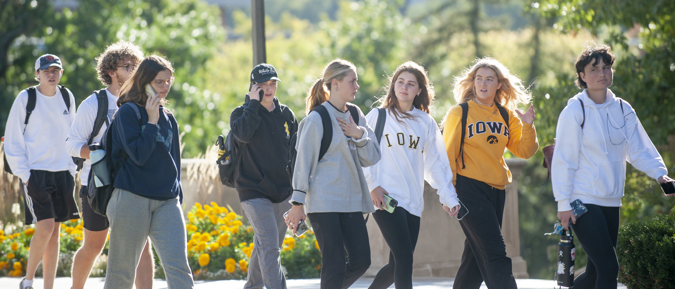 students walking on campus between classes